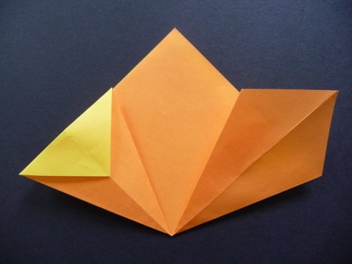 9.Valley fold the top part so the point aligns with the centre crease.